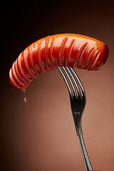 Image showing Grilled sausage on a fork