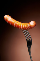 Image showing Grilled sausage on a fork