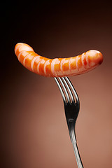 Image showing Grilled sausage on a fork