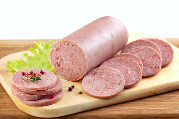 Image showing Salami sausage on wooden cutting board