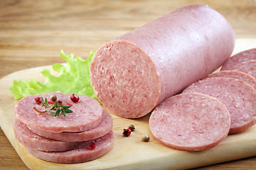 Image showing Salami sausage on wooden cutting board