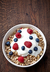 Image showing bowl of muesli and yogurt with fresh berries