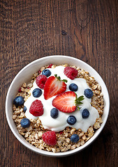 Image showing bowl of muesli and yogurt with fresh berries