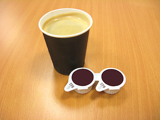 Image showing paper glass of coffee and two portion of cream