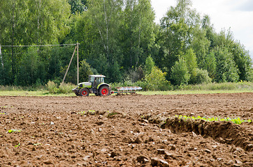 Image showing tractor plow agriculture field forest summer 