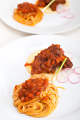 Image showing pasta with pork ribbs sauce on polenta bed