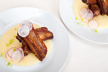 Image showing pork ribbs on polenta corn cream bed