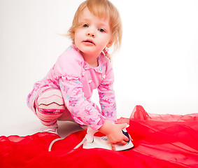 Image showing little, blond hair girl ironing