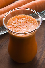 Image showing carrot juice on a wooden background 