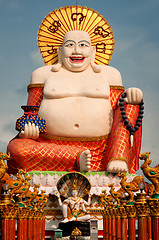 Image showing Fat laughing Buddha over blue sky