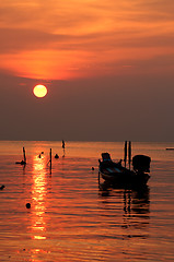 Image showing Sunset with boat on tropical beach