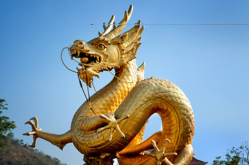 Image showing Golden dragon over blue sky