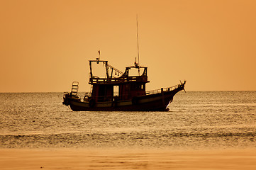Image showing Sunset with boat on tropical beach