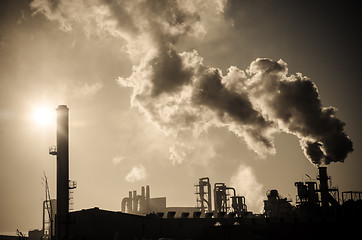 Image showing Smoking chimney  at sunset 