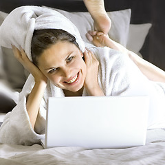Image showing happy woman on the bed with laptop