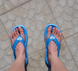 Image showing Feet in a pair of flip-flops