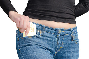 Image showing Pretty woman pulls out a bundle of money from a side pocket