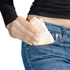 Image showing Woman's hand holding a bundle of banknotes isolate