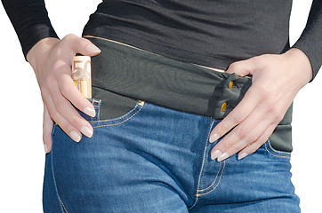 Image showing Woman with roll of 50 euro in side pocket isolated