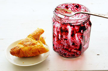 Image showing croissant and  pot of jam over white 