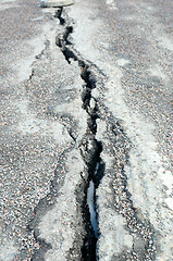 Image showing long crack stretching cross the sidewalk 