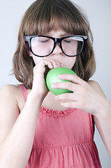 Image showing funny  girl with herd sunglasses blowing a balloon