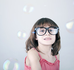 Image showing girl playing with soap bubbles