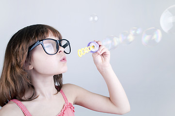 Image showing child blowing soap bubbles