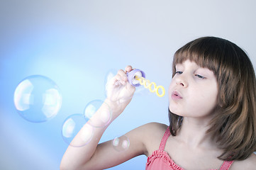 Image showing girl blowing soap bubbles