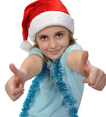 Image showing child wearing a Santa hat with thumbs up