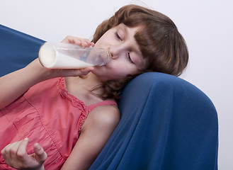 Image showing child drinking milk from a glass bottle