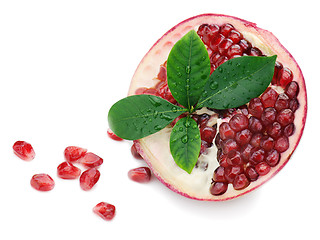 Image showing Pomegranate fruit with green leaves isolated on white background