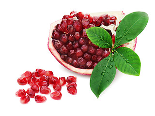 Image showing Part of pomegranate fruit with green leaves isolated on white ba