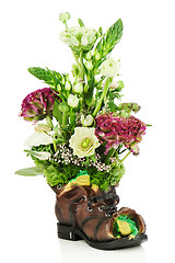 Image showing Flower bouquet arrangement centerpiece in old shoe with frogs is