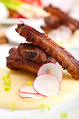 Image showing pork ribbs on polenta corn cream bed