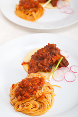 Image showing pasta with pork ribbs sauce on polenta bed