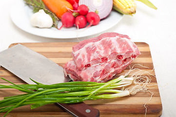 Image showing chopping fresh pork ribs and vegetables