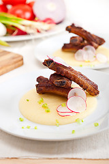 Image showing pork ribbs on polenta corn cream bed