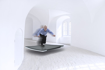 Image showing Senior businessman surfing on a tablet