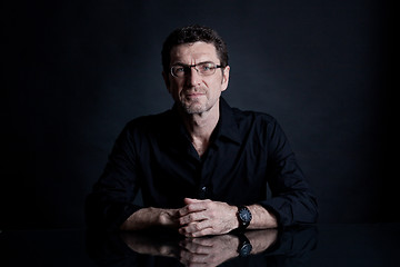 Image showing attractive adult man with glasses on black background