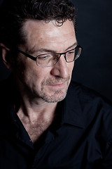 Image showing attractive adult man with glasses on black background