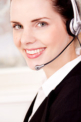 Image showing smiling young female callcenter agent with headset