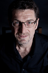 Image showing attractive adult man with glasses on black background