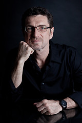 Image showing attractive adult man with glasses on black background