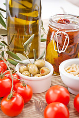 Image showing tatsty geen olives tomatoes and olive oil 