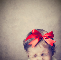 Image showing Small baby with silver gift box