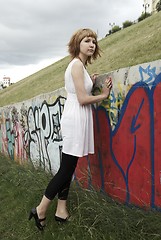 Image showing Attractive young woman against a wall of graffiti