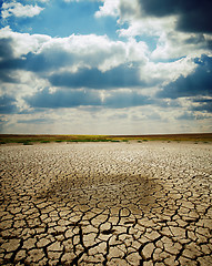 Image showing cracked earth under dramatic sky