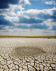 Image showing cracked earth under dramatic sky