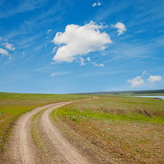 Image showing winding rural road to horizon under cloudy sky